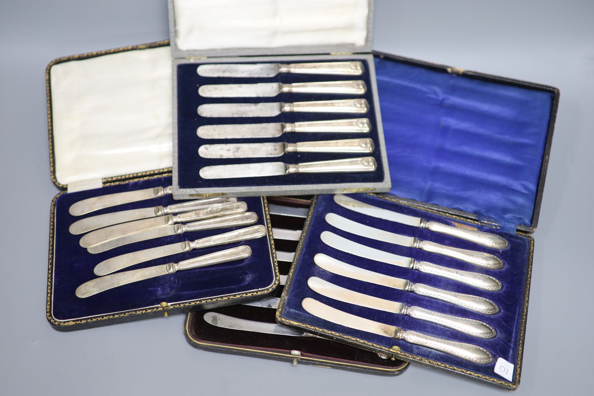 Seven assorted cased sets of silver handled tea knives including pistol handled.